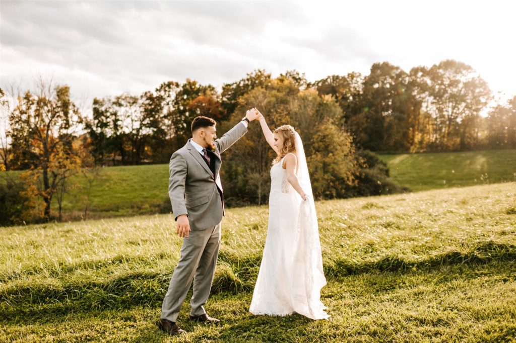 outdoor wedding with bride and groom dancing as the sun sets behind them for their Shenandoah National Park Wedding with Charlottesville wedding photographer