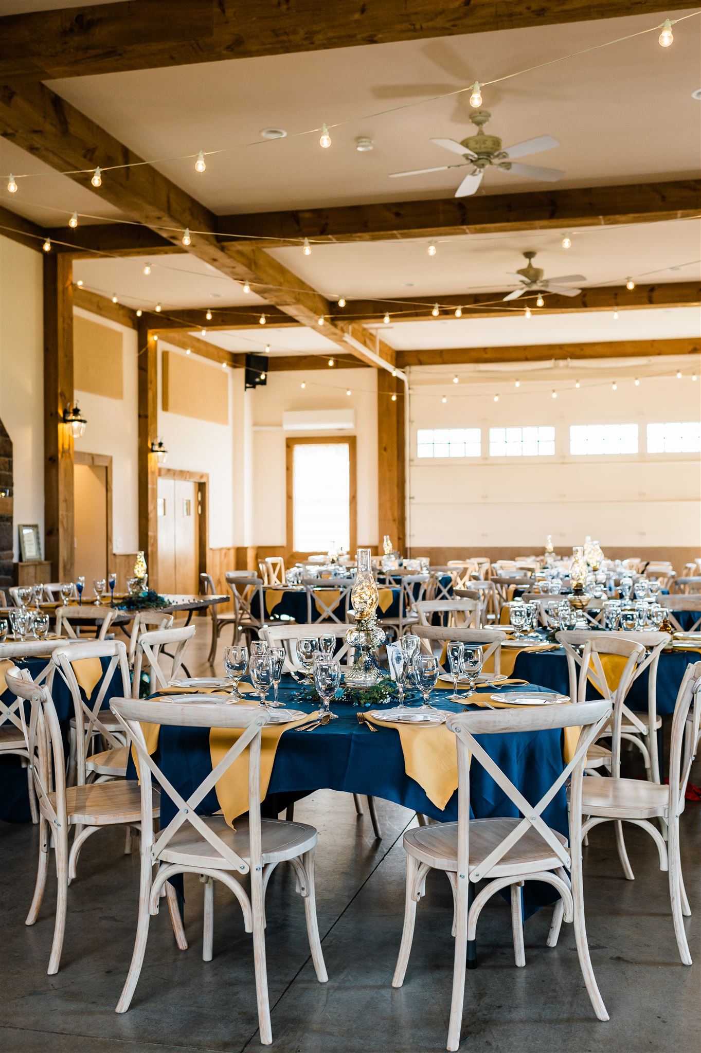 reception decor of royal blue and bright yellow for a stary night wedding in Shenandoah wedding venue with a rustic vibe captures by Charlottesville wedding photographers