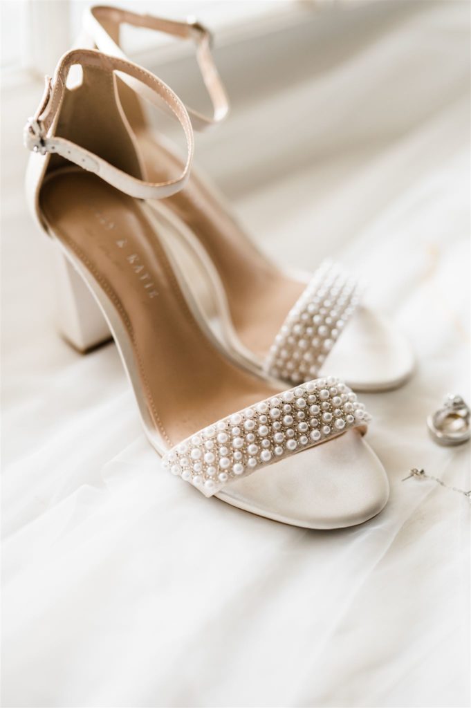 bridal shoes on a white surface captured by Charlottesville wedding photographer 