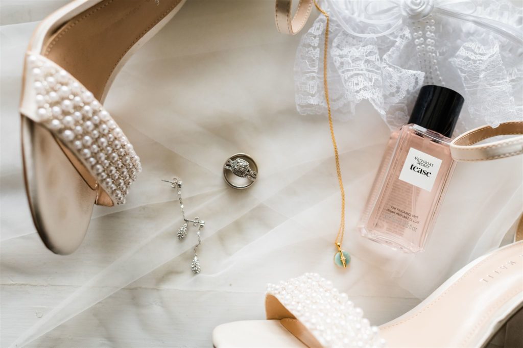 brides detail from the wedding day with her shoes, perfume, rings and so much more in a Shenandoah wedding flatlay photo by Charlottesville wedding photographer 