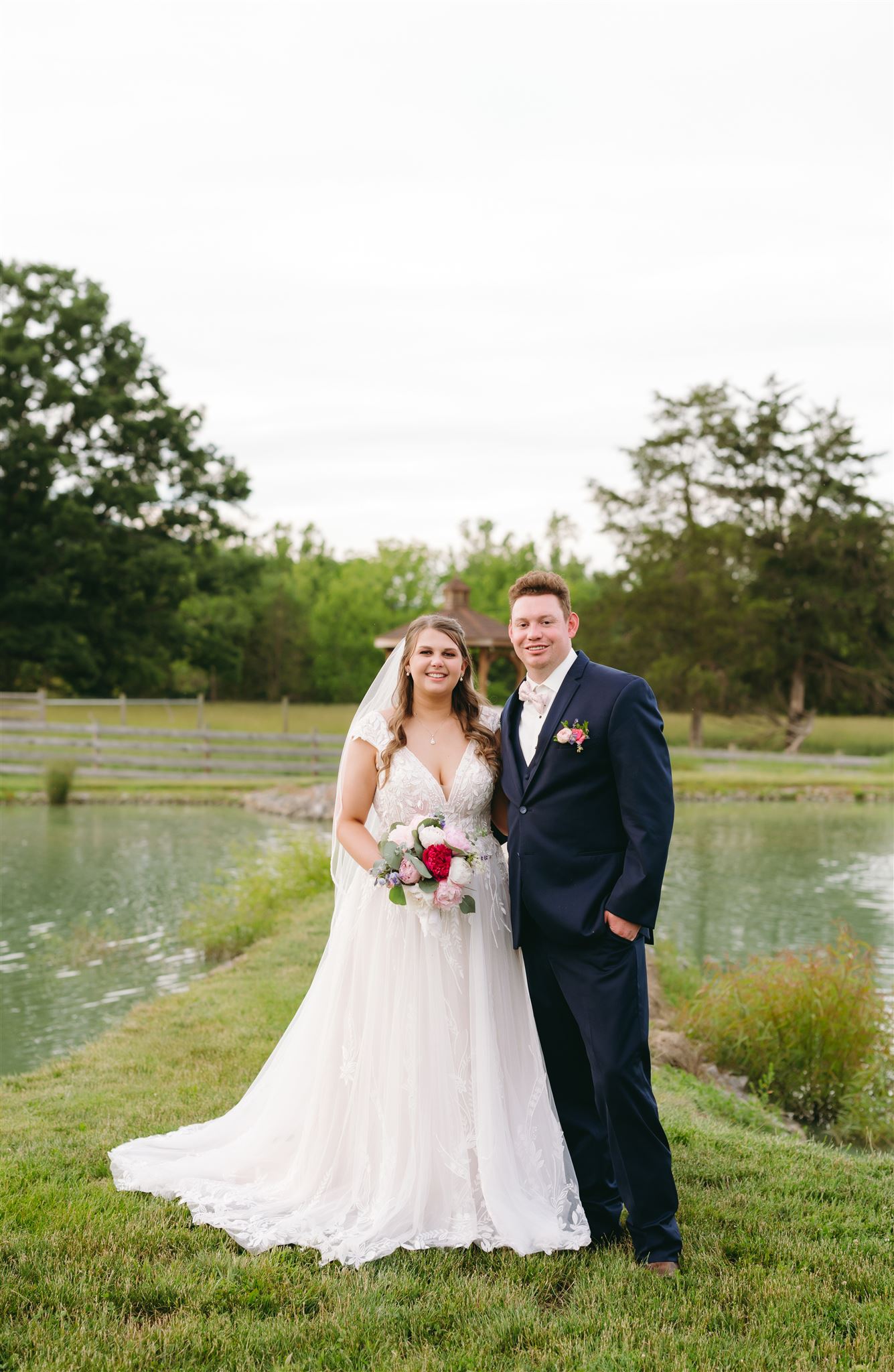 Charlottesville wedding photographer photographs bride and groom portrait in front of a lake at their Virginia wedding venue