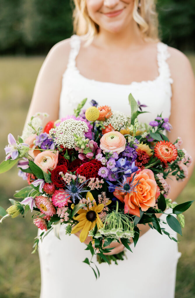Close up of Zoey's Fall floral bouquet surrounded by the sunset fields