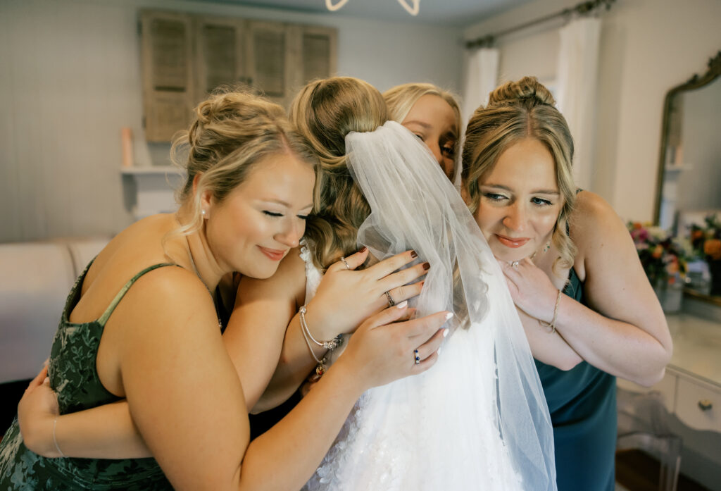 Zoey and bridesmaids embracing after bridesmaid first look