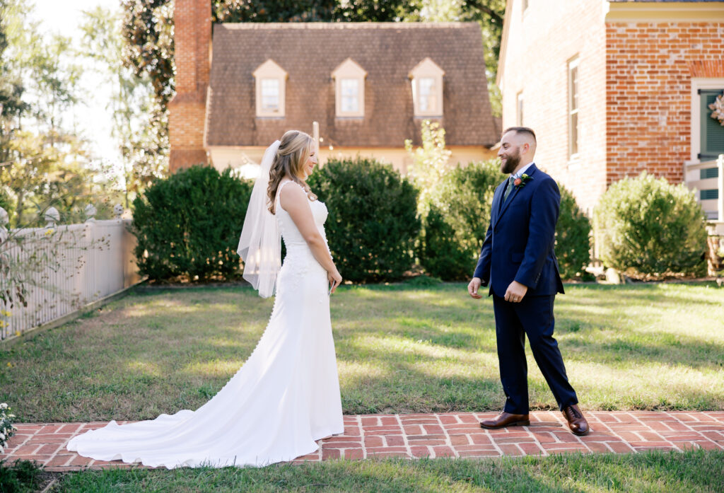 Zoey and Brandon's first look in front of the Manor House at Seven Springs.